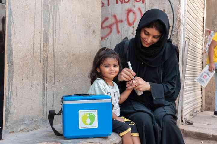 Frontline health worker with a child