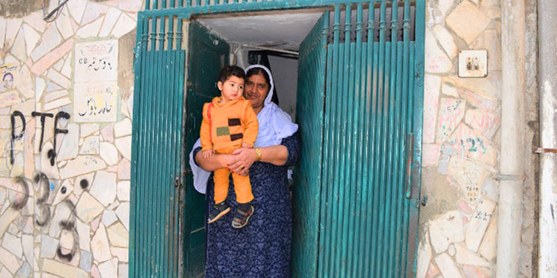 Grandmother holding her grandson after vaccination