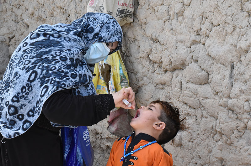 Resumption of Covid following the SOPS, polio worker vaccinating child in pakistan.
